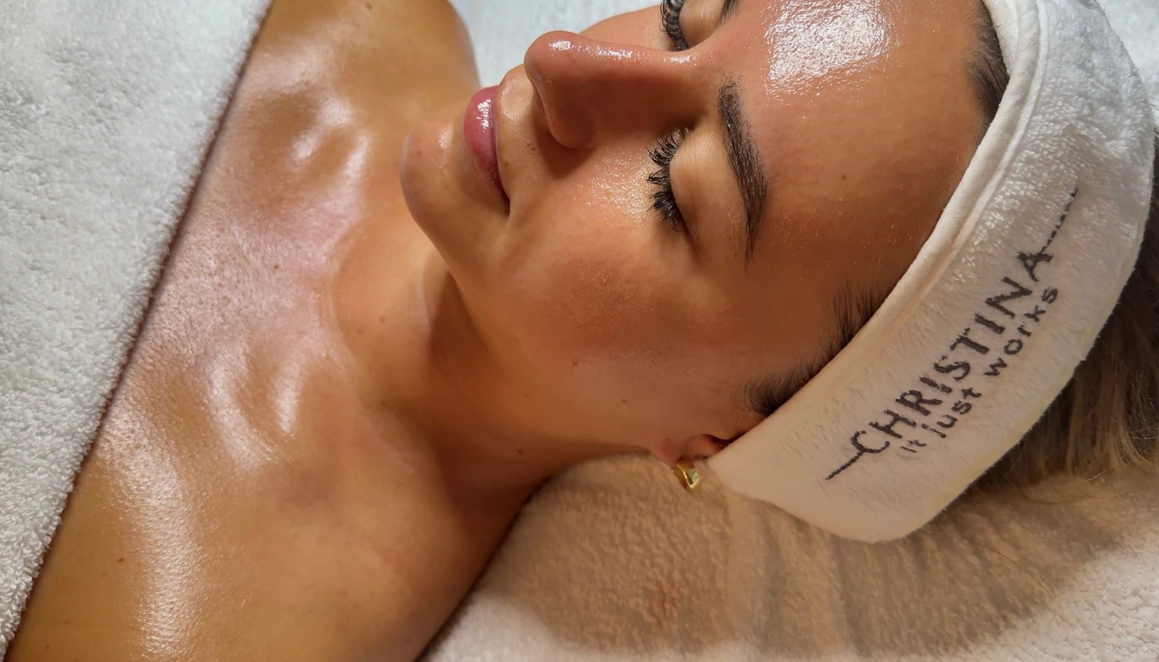 Client relaxing during a professional facial treatment at Hydraderm Spa